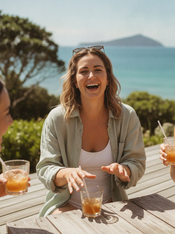 Laughing with friends on Takapuna beachside wooden deck